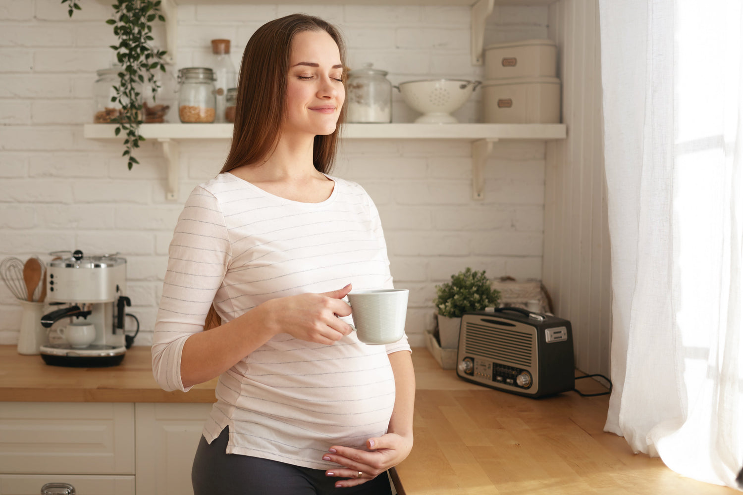 Pregnant woman holding a mug