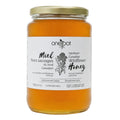 A glass jar of OneRoot Northern Canadian Wildflower Honey with a gold metal lid and a white label, set against a plain white background.